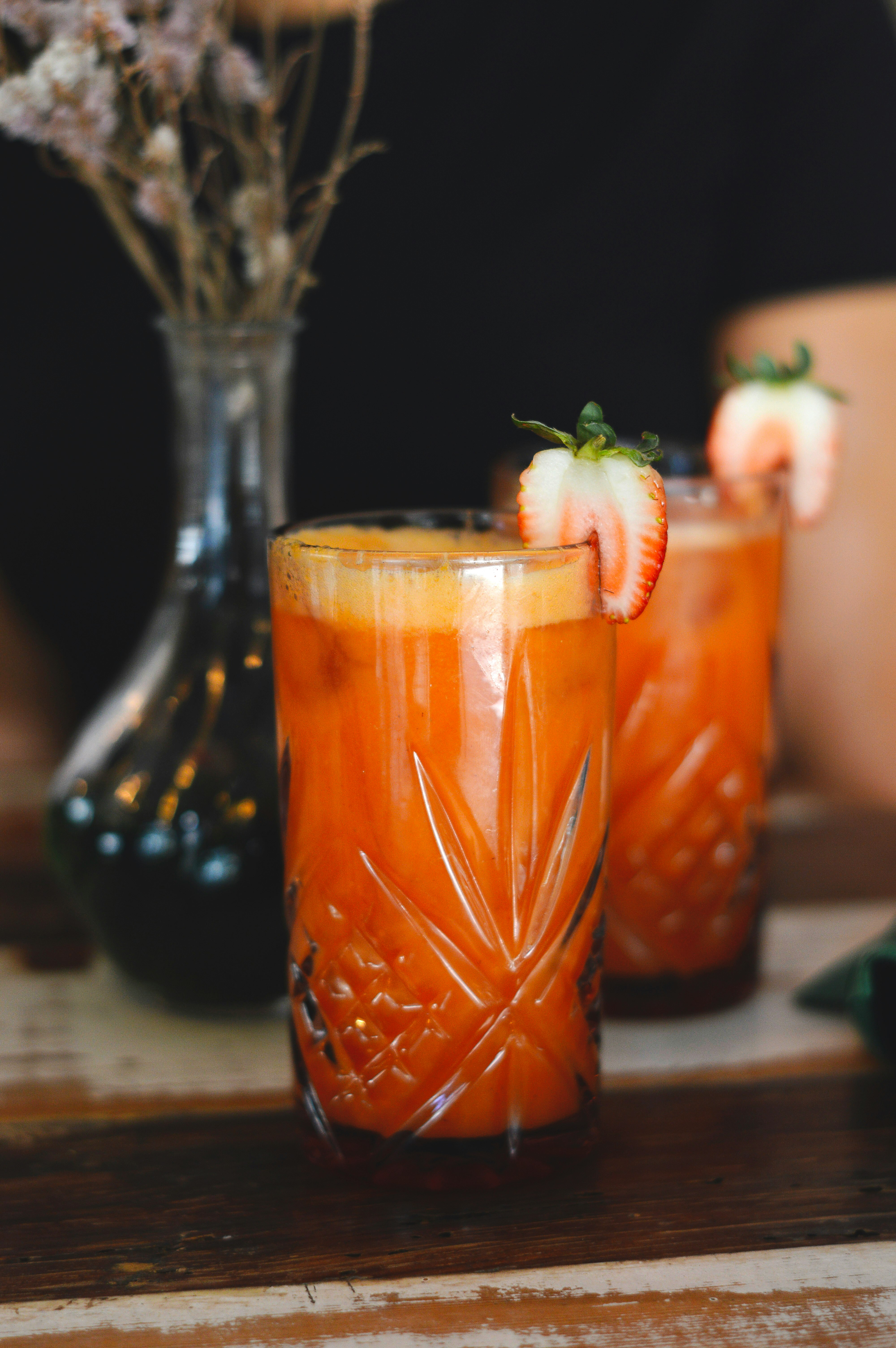 clear drinking glass with orange liquid